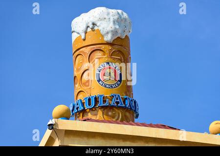 Munich, Bavaria, Germany - 23 September 2024: The iconic Paulaner Tower with a giant beer mug towers over the Oktoberfest and symbolizes the Bavarian beer tradition *** Der ikonische Paulaner-Turm mit einem riesigen Bierkrug überragt das Oktoberfest und symbolisiert die bayerische Biertradition Stock Photo