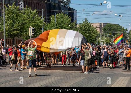 Bear with Us Helsinki members flying a giant International Bear Brotherhood Flag at Helsinki Pride 2024 parade on Mannerheimintie in Helsinki, Finland Stock Photo