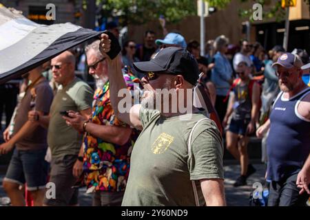 Bearded man holding a corner of a huge bear flag at Helsinki Pride 2024 parade on Mannerheimintie in Helsinki, Finland Stock Photo