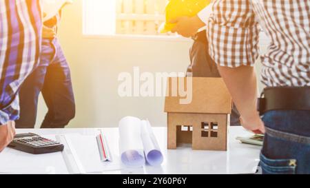 Plans and documents are placed on desks in the engineering team's office to prepare for the meeting of the designers, engineers and foreman teams to s Stock Photo