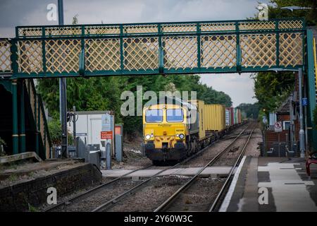 Freight train passing through Trimley on route to the port off Felixstowe Suffolk Stock Photo