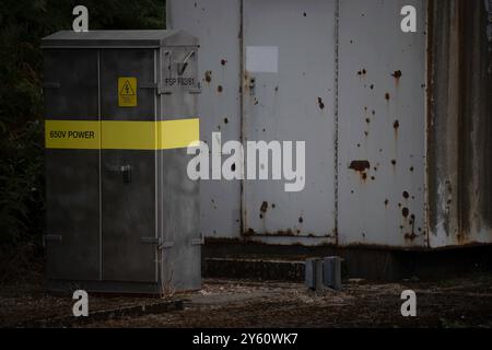 650 volt electricity transformer box beside a railway line Stock Photo