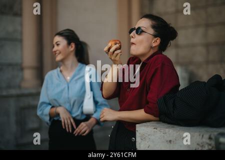 Young businesspeople meeting outdoors enjoying a break and socializing Stock Photo