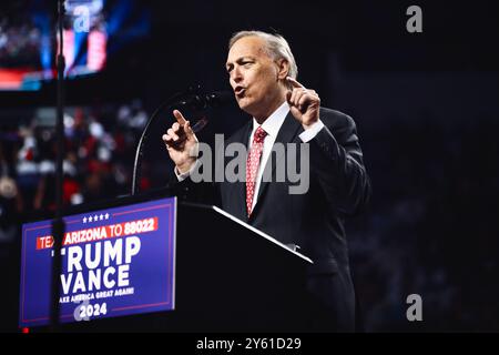 Glendale, Arizona, USA - 23 August 2024: Congressman Andy Biggs speaking behind a podium at a political campaign rally in an arena, endorsing the Trum Stock Photo