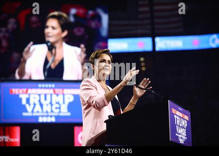 Glendale, Arizona, USA - 23 August 2024: Republican nominee Kari Lake speaking behind a podium at a political campaign rally in an arena, endorsing th Stock Photo