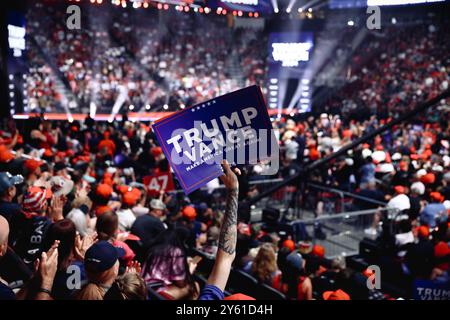 Glendale, Arizona, USA - 23 August 2024: a white Caucasian man holding up a 'Make America Great Again' sign among supporters of Donald Trump gathered Stock Photo