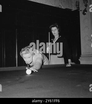 Billiards playing housewifetLondon:  Taking a practice shot at Burrooughes & Wats Hall , Soho Square , London is Mrs Dorothy Thompson , of Beckenham , Kent , a houeswife and golf player , and holder of the Southern Counties Billiards Cup , watched by Mrs Katherine Cotton of Sutton , Surrey .  Both are competitors in the Women's Billiards and Snooker Amateur Championships which commenced at the hall today 2 May 1960 Stock Photo