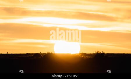 long pause shot at sunset on a Mediterranean beach, water movement, golden hour and landscape inspiring tranquility and fullness Stock Photo