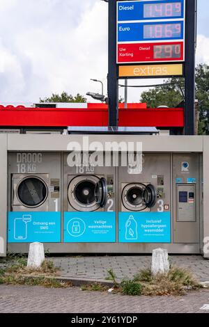 Self-service washing machines, for laundry, clothing, open 24 hours, around the clock, at a gas station, on the border of Germany and the Netherlands Stock Photo