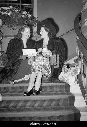 Thirty-five leading British screen stars who this afternoon will appear in excerpts from their films of last year in the British Film Festival at the Odeon Theatre, Leicester Square, where at the theatre for rehearsals this morning. The show is being held in conjunction with the National Film Awards organised by the Daily Mail. Picture shows: Film stars Patricia Roc (left) and Margaret Lockwood find seat on the stairs at the theatre, Leicester Square this morning.  1 February 1948 Stock Photo