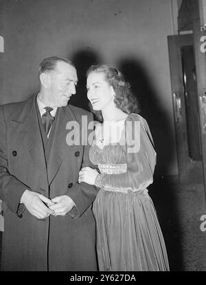 The Casino Theatre, London, was booked in its entirety this evening by J Arthur Rank star Patricia Roc, who invited an audience of her fans from all over London to see the pantomime 'Cinderella', starring Arthur Askey. Picture shows: Patricia Rock, made more footage of film last year than any other British star, gets acquainted with Mr Tory Bailey, one of the guests tonight. Mr Bailey, of The Canterbury Arms, Kilburn, pulled 44,200 pints of beer during 1947- which he claims, is a record figure.  2 February 1948 Stock Photo