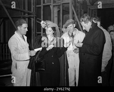 Screen star Danny Kaye 'dropped in' at Teddington Studios today to perform the reopening ceremony. The studios have been rebuilt after the fly-bombing of July 1944, as a result of the efforts of Jack L. Warner of Warner Bros. Pictures Ltd. Picture shows:  Danny Kaye and Pat Kirkwood sign autographs. Stock Photo