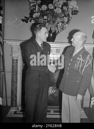 United States awards and decorations for services to the Allied cause during the war, were presented today to 25 British officers and civilians and one Greek citizen, by Col Ernest Bomar, United states Deputy Military Attaché, at the residence of the US Ambassador in London. Picture shows:  Sergeant J.D. Vallely, of Carlisle with the Col Bomar during the ceremony  where he was awarded the Medal of Freedom of presentation.  15 January 1948 Stock Photo