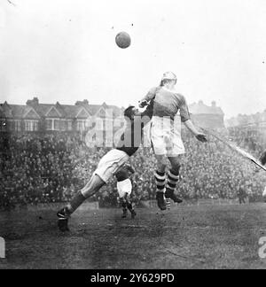 In the first round proper of the FA Cup, Crystal Palace, were at home to Port Vale at Selhurst Park today. Picture shows: Kurz, the Palace centre-forward, goes up to head into goal as Heppel the Port Vale goalie leaps to punch clear an incident during this afternoon's cup-tie at Selhurst Park.  29 November 1947 Stock Photo