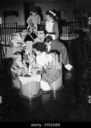 Britain's first 'Lorna', 34-year-old Miss Margaret Elsie Sterne, of Leeds, who was recently chosen as the ideal laundress, visited the Queen Elizabeth Hospital for children at Hackney, where she distributed Christmas gifts to the child patients. 'Lorna' is in London to attend tomorrow's tea party at Buckingham Palace as the representative of Britain's laundry workers. 60,000 of them contributed some of £1,500 as a wedding gift to the Princess Elizabeth £1000 of this will be used to endow a ward at the hospital 'Lorna' visited today. Some other hospitals will benefit from the other £500. Pictur Stock Photo