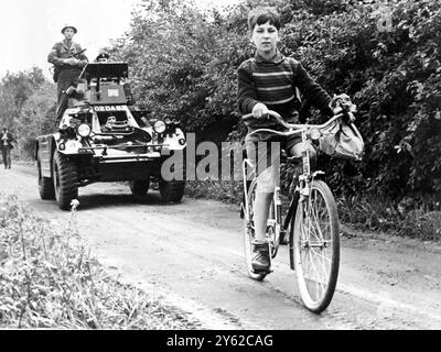 Armoured escort for schoolboy. Berlin ;  A twelve - year old schoolboy , Erwin Schabe cycles to school here today, escorted by a British armoured car after the East German People's Police had stopped him several times on the pathway inside the Western Zone.  26 August 1961 Stock Photo