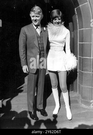 Cilla Black, wearing a white jersey mini dress and matching white boots, with her husband-manager Bobby Willis at the entrance of the parish church of St Mary's Woolton after their wedding ceremony. 6th March 1969 Stock Photo