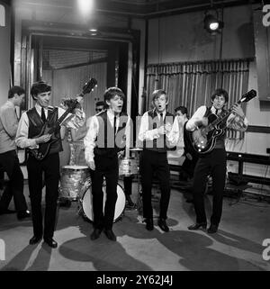 The Rolling Stones performing in the television studio . Pictured from left to right ; Bill Wyman , Mick Jagger , Brian Jones and Keith Richards . Early 1960s Stock Photo