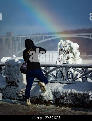 Looking at the Rainbow Bridge in Niagara Falls, Canada.  Winter time, rainbow present. Stock Photo