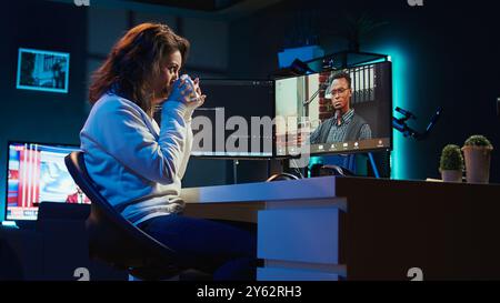 Software engineer teacher doing online tutoring, talking with student in online videocall about ways to do debugging. IT master teaching apprentice in webinar how to write code, camera B Stock Photo