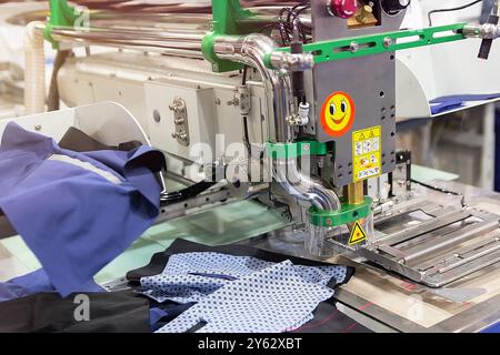 Modern embroidery machine in garment indystry. Clothing factory Stock Photo