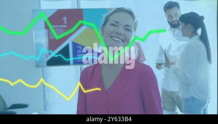 Green line graph image over business people working in modern office Stock Photo