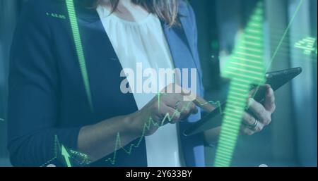 Analyzing financial data over businesswoman using tablet Stock Photo