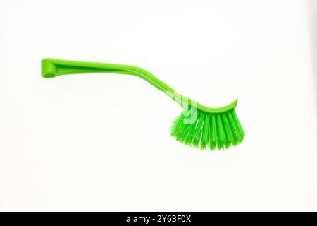Plastic brush with green bristles for home cleaning. Stock Photo