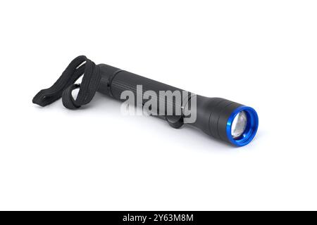 Black flashlight featuring a blue lens and wrist strap. Ideal for camping, emergencies, or everyday use. High-quality lighting tool against a white ba Stock Photo