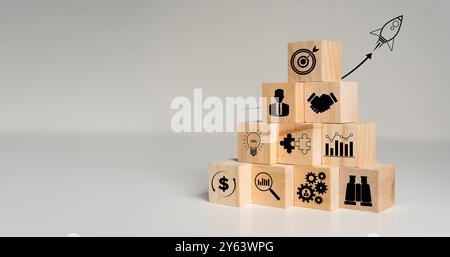 Rocket launching from wood cube with business icon, Start-up, Creativity, Big idea, Business goals management, Investment on new project to wealth, Co Stock Photo