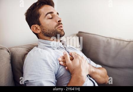 Man, chest pain and heart attack with stress in home for medical emergency, discomfort and cardiac arrest. Professional, person and cardiovascular Stock Photo