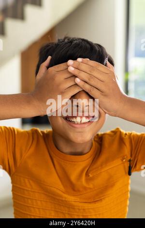 Boy covering eyes with hands Stock Photo - Alamy
