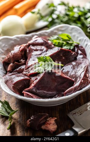 Sliced ​​beef liver in a white bowl, ready to cook. Stock Photo