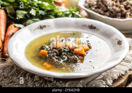 Broth with liver gnocchi made from beef liver, bread, eggs and parsley cooked in beef broth. Leberknödelsuppe – German Liver Dumpling Soup. Stock Photo