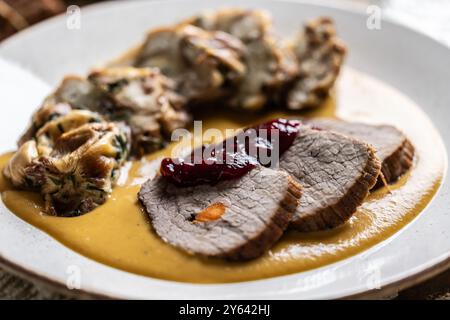 Beef fillets from sirloin steak with traditional Czech sauce, Karlovy Vary dumpling with cranberries and good Czech beer. Stock Photo