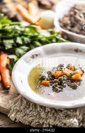 Broth with liver gnocchi made from beef liver, bread, eggs and parsley cooked in beef broth. Leberknödelsuppe – German Liver Dumpling Soup. Stock Photo