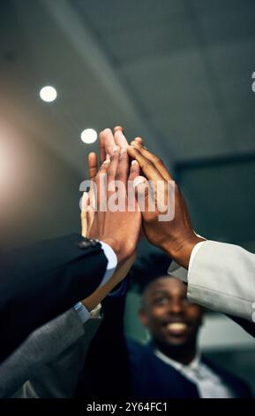 Business people, high five and hands together for teamwork, celebration and collaboration success in office. Group, employee and workers with Stock Photo