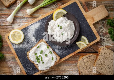 Delicious healthy breakfast with fish roe spread, chives and bread on rustic wooden table Stock Photo