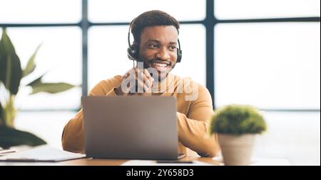 Happy afro manager working in call centre Stock Photo