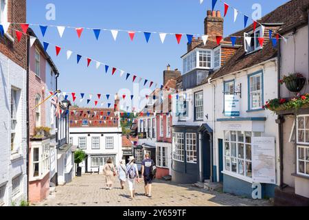 Lymington Hampshire - People walking down Quay Hill a steep street with Bunting in Lymington a town in the New Forest Hampshire England UK GB Europe Stock Photo