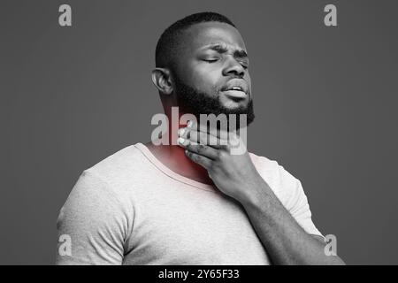 Sad afro man suffering from sore throat Stock Photo