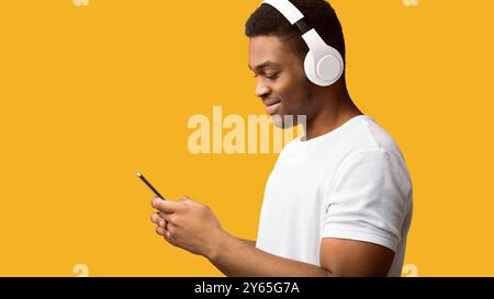 Side view of black man in wireless headphones Stock Photo