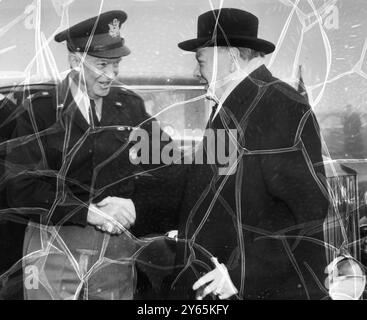 Churchill Meets ' Ike ' . Winston Churchill ( right ) Britain ' s Prime Minister , shakes hands with General Eisenhower , Supreme Commander of the Atlantic Pact Forces in Europe , when he visited the General at his headquarters .  18 December 1951 Stock Photo