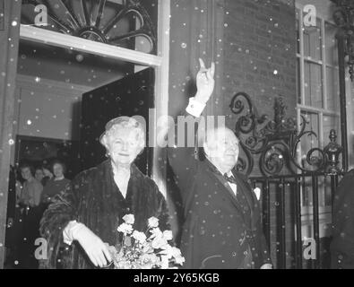 His Day . Prime Minister , Sir Winston Churchill gives his well known ' V ' sign , as with Lady Churchill , he arrives back at No .10 Downing Street after the State Opening of Parliament and ceremonies marking his 80th birthday .  1954 Stock Photo