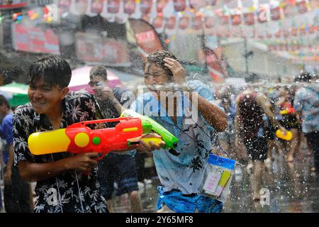 Bangkok, Thailand - April 13, 2023: People splash water using water guns during the celebration of Songkran festival, Thai New Year, in Khaosan Road. Stock Photo