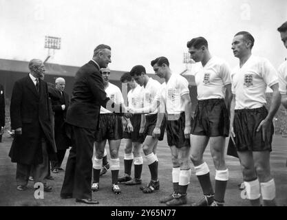 Earl Mountbatten of Burma of shakes hands with English footballer Johnny Haynes as he goes down the line of the English team which includes Stanley Matthews .  England were playing the Republic of Ireland in a World Cup match at the Empire Stadium , Wembley , London . 8th May 1957 Stock Photo