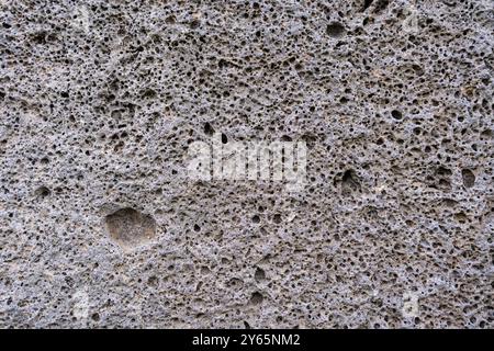 Close-up image of the porous, textured surface of a rock at the Tedjisi megalith site in Georgia, highlighting the geological intricacies Stock Photo