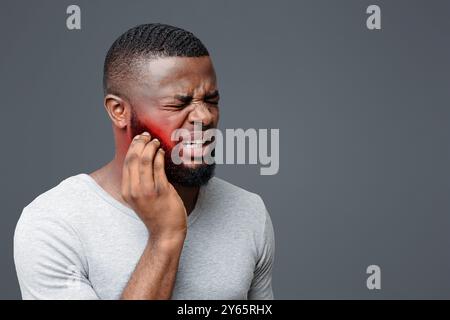 Young afro man having wisdom teeth problem Stock Photo