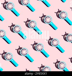 A seamless pattern of blue circular hand fans with delicate designs, set against a soft pastel pink background Stock Photo