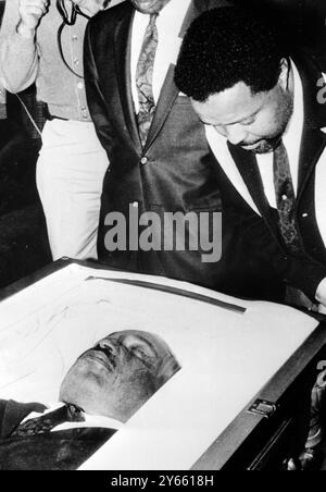 Atlanta : The Rev . Hosea Williams , one of Dr Martin Luther King's chief aides in his civil rights battles  , bends over to get a close look at Dr King's body as it lay in state at Sister's Chapel at Spellman College .  Today it was transferred to Ebenezer Baptist Church for a further period of lying in state .   8 April 1968 Stock Photo